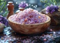 Himalayan pink salt in wooden bowl and lavender flowers on dark table Royalty Free Stock Photo