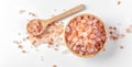 Himalayan pink salt in wooden bowl with spoon on white background Royalty Free Stock Photo