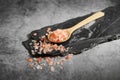 Himalayan pink salt in wooden spoon on rustic background Royalty Free Stock Photo