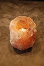 Himalayan Salt Lamp Candle Lit on stone