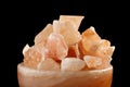 Himalayan salt lamp close up isolated on the dark background