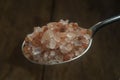 Himalayan salt silver spoon. Close-up. Royalty Free Stock Photo