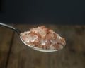 Himalayan salt silver spoon. Close-up. Royalty Free Stock Photo