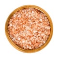 Himalayan salt in wooden bowl over white