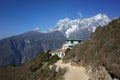 Himalayas mountains landscape with trail to guest house hidden half behind green hill