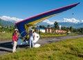 HIMALAYAS, POKHARA, NEPAL. 28 September 2008: Foreign tourist prepares for flight on a hang glider deltaplan.