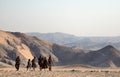 A Himba family walking in the desert.