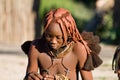 Himba woman looks down, Namibia.