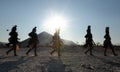 Himba women walking back after collecting water in containers on their heads, Epupa, Kunene Region, Namibia.