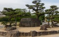 Himeji Castle Stone Monument, lettering in engl. UNESCO World Heritage, on a clear, sunny day with many green around. Himeji,