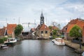 HINDELOOPEN, FRISLAND/THE NETHERLANDS - JULY 2, 2020: Lock with the wooden drawbridge and the lockkeeper`s house Royalty Free Stock Photo