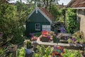 Colorful sculptures and a wooden shed in a garden in the Frisian