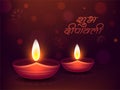 Hindi text of Shubh Deepawali and illuminated oil lamp Diya on brown mandala pattern background.