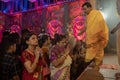 Hindu Bengali sari clad women praying to Goddess Durga inside Durga Puja pandal. Ashtami puja aarati at night. Biggest fetsival of Royalty Free Stock Photo