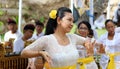 Hindu celebration at Bali Indonesia, religious ceremony with yellow and white colors, woman dancing.