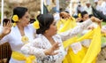 Hindu celebration at Bali Indonesia, religious ceremony with yellow and white colors, woman dancing.