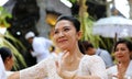 Hindu celebration at Bali Indonesia, religious ceremony with yellow and white colors, woman dancing.