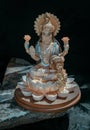 Hindu cosmos Maha laxshmi statue decorated with Flower Garland. Statue of Goddess of Wealth