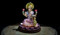 Hindu cosmos Maha laxshmi statue decorated with Flower Garland. Statue of Goddess of Wealth