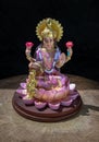 Hindu cosmos Maha laxshmi statue decorated with Flower Garland. Statue of Goddess of Wealth