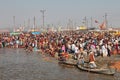 Hindu devotees come to confluence of the Ganges for holy dip during the festival Kumbh Mela Royalty Free Stock Photo