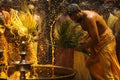 Hindu devotees perform the turmeric bathing ritual during the annual festival held at Amman temple