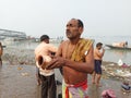 A hindu devotees performing surjo namaskar after the ganges bath as a ritual.