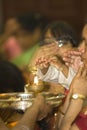 Hindu devotees put their hands over a flame Royalty Free Stock Photo