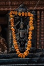 Hindu diety statue tablet with orange flowers in Durbar Square, Kathmandu, Nepal Royalty Free Stock Photo