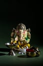 Hindu God Ganesha. Ganesha Idol. A colorful statue of Ganesha Idol on dark background. space for text or headline