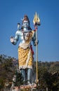 Hindu god shiva statue with bright blue sky background at morning from different angle Royalty Free Stock Photo