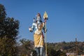 Hindu god shiva statue with bright blue sky background at morning from different angle Royalty Free Stock Photo