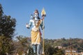 Hindu god shiva statue with bright blue sky background at morning from different angle Royalty Free Stock Photo