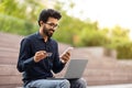 Hindu man freelancer using laptop, phone and credit card Royalty Free Stock Photo