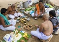 Hindu men at prayer in a makeshift temple - India