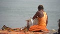 Hindu Pandit doing something near Ganga river