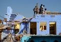 Hindu people building a blue house