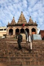 Hindu pilgrims climb up the steps of a temple