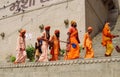 Hindu piligrims sadhu in orange clothes on the streets in India