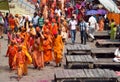 Hindu piligrims sadhu in orange clothes on the streets in India