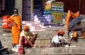 Hindu piligrims sadhu in orange clothes on the streets in India
