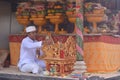 Hindu priest blessing Balinese family celebrating Galungan Kuningan holidays in Bali Indonesia