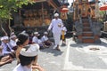 Hindu priest blessing Balinese family celebrating Galungan Kuningan holidays in Bali Indonesia