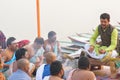 Hindu priest performing religious rituals at Ganges river bank in Varanasi, India