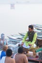 Hindu priest performing religious rituals at Ganges river bank in Varanasi, India