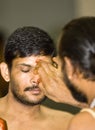 Hindu priest places a mark on the forehead Royalty Free Stock Photo
