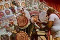 Hindu priest putting garlands on Goddess Durga before Sandhi Puja, the sacred juncture of