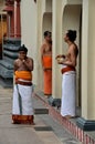 Hindu priests relax after morning rituals