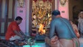 Hindu Purohit raising fire of yajna to worship Goddess Durga for Ashtami puja aarati.