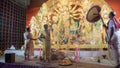 Hindu Purohits worshipping Goddess Durga , devotee with big hand fan airing her